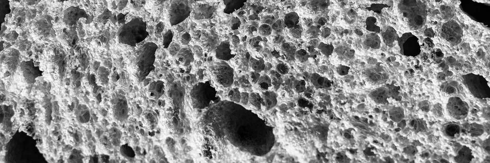 Gray texture of white bread close up background. backdrop of rough dappled te Stock Photos