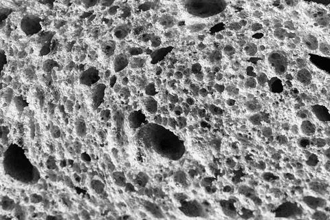 Gray texture of white bread close up background. backdrop of rough dappled te Stock Photos