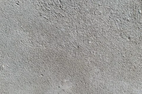 Gray textured cement wall background with fine concrete chips. Construction Stock Photos