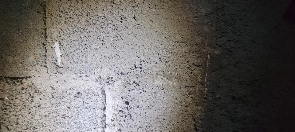 Gray textured cement wall featuring coarse plaster, weathered appearance an.. Stock Photos