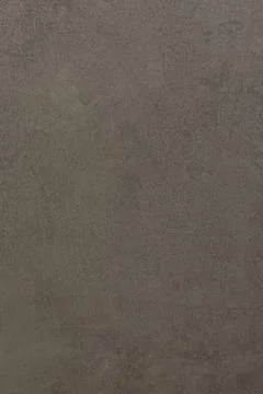 Gray textured surface shows subtle variations and patterns in natural light at Foto stock