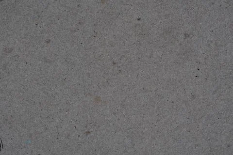Gray textured surface with small spots and white background Stock Photos