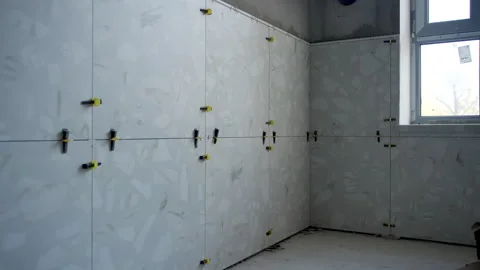 Gray tiles with marble pattern cover walls in bathroom Stock Footage 333212097