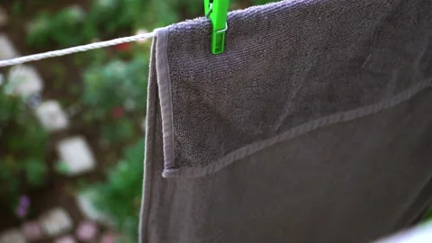 A gray towel develops from the wind, linen is dried on a rope Stock Footage 131468476