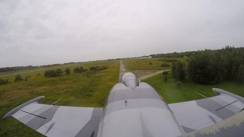 Gray training fighter plane flies very quickly and low above ground. Top view. Stock Footage 118677433