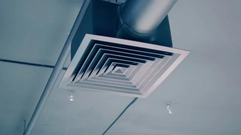 Gray ventilation pipe with a grill near the ceiling in a warehouse building Stock Footage 323936285