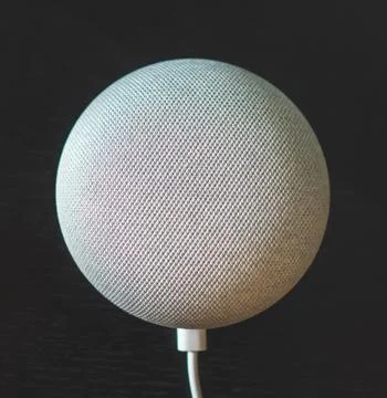 Gray voice controlled mini smart speaker on black background Stock Photos