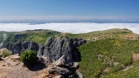 Gray volcanic cliffs and emerald-covered slopes at Pico do Arieiro, Madeira.. Фото