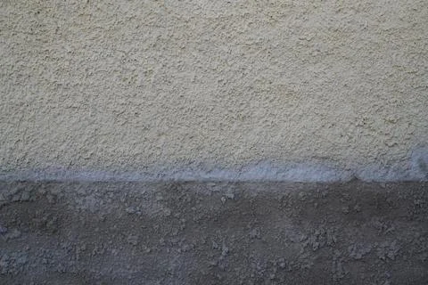 Gray wall background of an old building painted in old white with touch ups.. Stock Photos