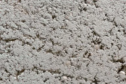 Gray wall background of sand with seashells and cement. Stock Photos