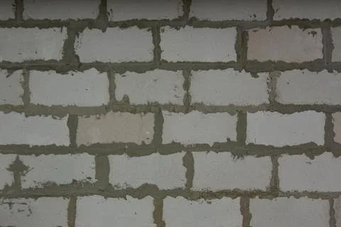 A gray wall of brick blocks. Brick texture made of rectangular gray elements Stock Photos