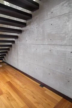 Gray wall in interior with view of staircase Stock Photos