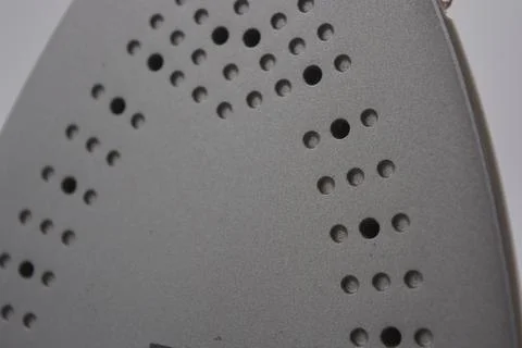 Gray white plastic iron with sprayer, metal bottom is on a white plastic. 写真素材
