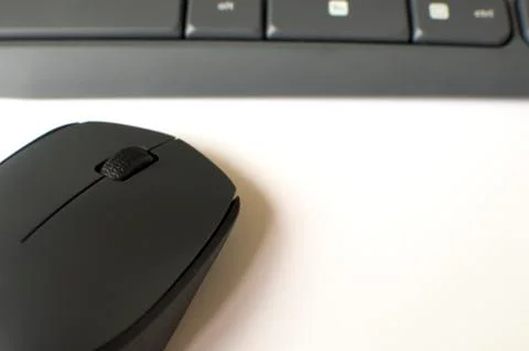 A gray wireless mouse and a keyboard Stock-Fotos