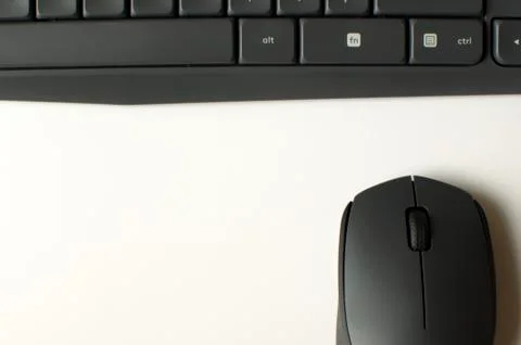 A gray wireless mouse and a keyboard Stock-Fotos