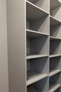 Gray Wooden Shelving Unit With Multiple Empty Shelves Stands Tall Stock Photos