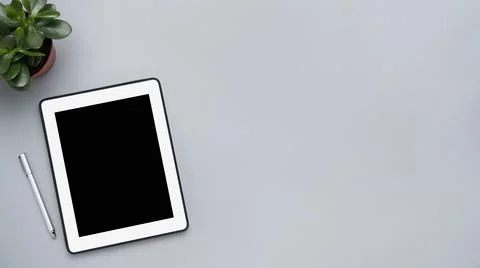 Gray workspace and white tablet with a blank screen 写真素材