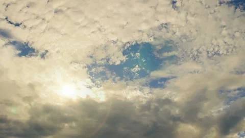 Gray-yellow clouds float over the blue sky Stock Footage 137932431