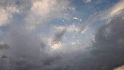 Gray-yellow clouds float over the blue sky Stock Footage 137932500