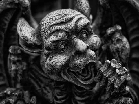 Grayscale closeup of gargoyle statue face Foto stock