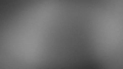 Grayscale grainy texture background with gradient blur effect for tech wall.. Stock-Fotos