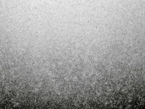Grayscale noise gradient texture, fading from light to dark speckles for abst Stock Photos