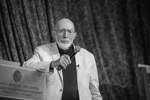 Grayscale of a physicist Kip Thorne delivering a lecture on stage during the STA Stock Photos