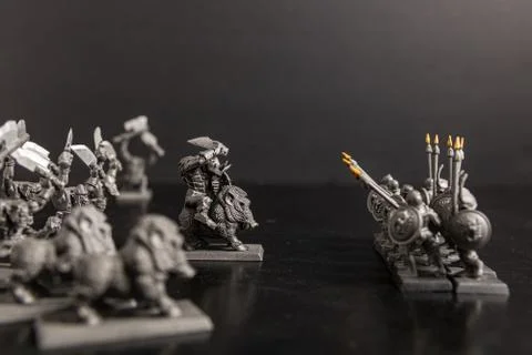 A grayscale selective focus shot of  mythical creature and soldier with spear Foto stock