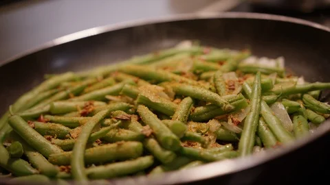 Grean beans being sauteed and cooked in pan with onions Video stock 124225371