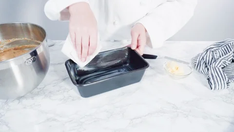 Greasing bread pan to bake banana bread. Stock Footage 119077895
