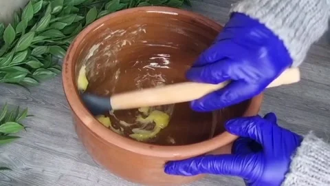 Greasing Clay Pot with Ghee for Traditional Qidreh Cooking Stock Footage 343879582
