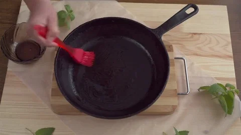 Greasing of a frying pan olive oil. Stock Footage 69075464