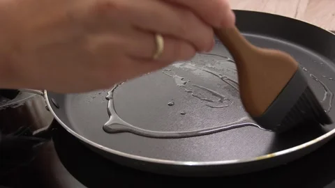Greasing the pan with a brush. Stock Footage 255251635