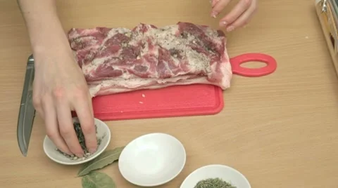 Greasing piece of bacon with garlic, pepper and salt mixture Stock-Footage 7740861