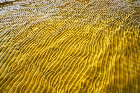 Great background whimsical patterns on the sand across the water horizontal Stock Photos
