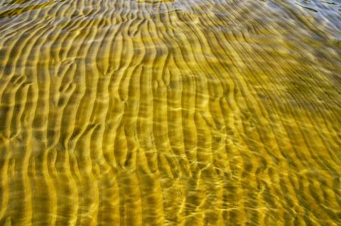 Great background whimsical patterns on the sand across the water horizontal Stock Photos