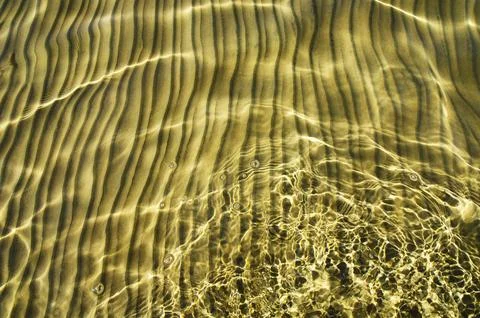 Great background whimsical patterns on the sand across the water horizontal Stock Photos