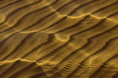 Great background whimsical patterns on the sand across the water horizontal Stock Photos