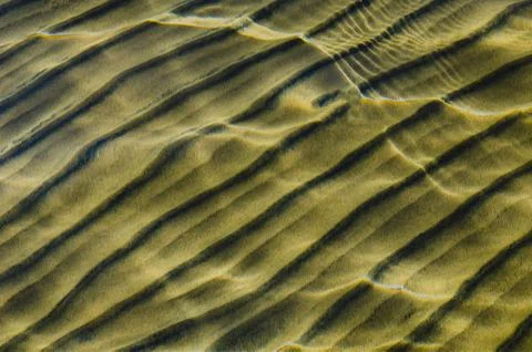 Great background whimsical patterns on the sand across the water horizontal Stock Photos
