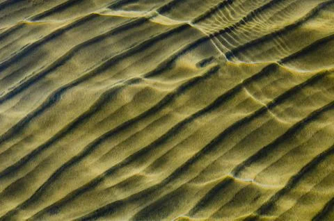Great background whimsical patterns on the sand across the water horizontal Stock Photos