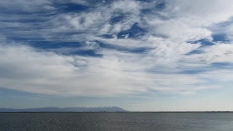 Great Bear Lake timelapse shows cirrus clouds across blue white - Water Surface Stock Footage 339794630
