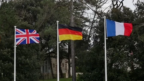 Great Britain, German and French flags waving on a pole. Slow motion shot of Stock Footage 150473353
