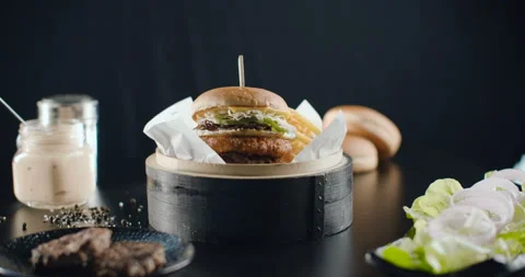 Great Burger with beef cutlet, cabbage, onion and cucumbers with french fries Stock Footage 102167813