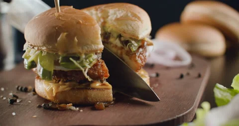 Great Burger with beef cutlet with melted cheese rotates cut with large knife Stock Footage 102370511