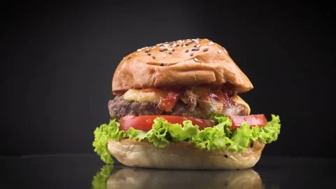 Great burger with beef cutlet, tomatoes and green salad with melted cheese .. Stock Footage 233396936