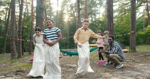 Great competition. Full length view of the happy diverse children jumping at the Stock Footage 162114192