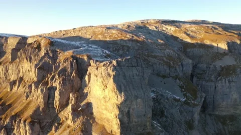 Great flight around a big cliff in the swiss alps at sunset. Stock Footage 173813480