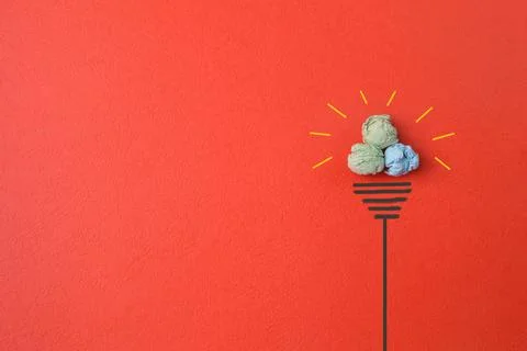 Great idea concept with light bulb crumpled paper isolated on red background Stock Photos