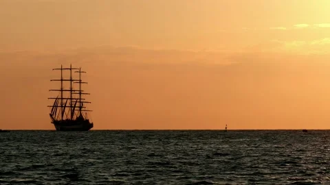 Great Large three-masted Sailing ship floats on the high seas. during sunset Stock Footage 148014296