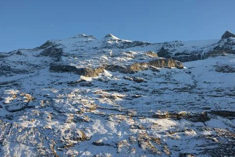 Great light and shadow play on a snowy mountain in Switzerland. Stock Photos
